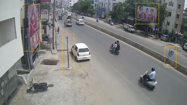 Illegal hoardings and damaged signs on a CCTV camera